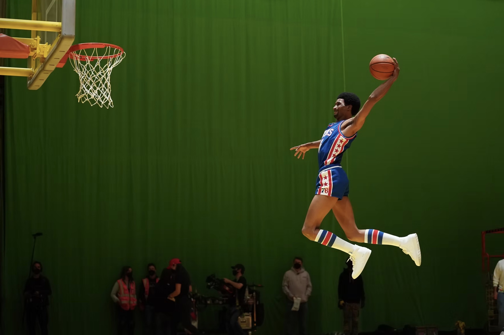 Winning Time basketball player jumping toward a hoop against a green screen