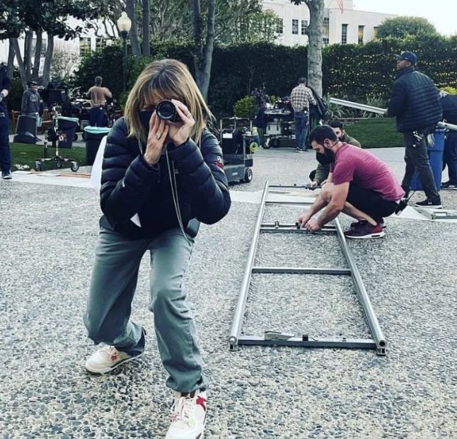 Christine Lakin directing on set through a camera lens