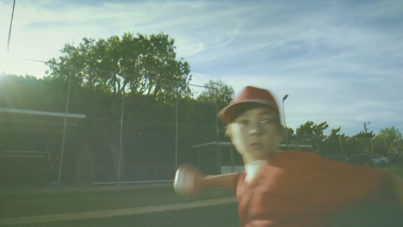 Young baseball players celebrating on a little league field