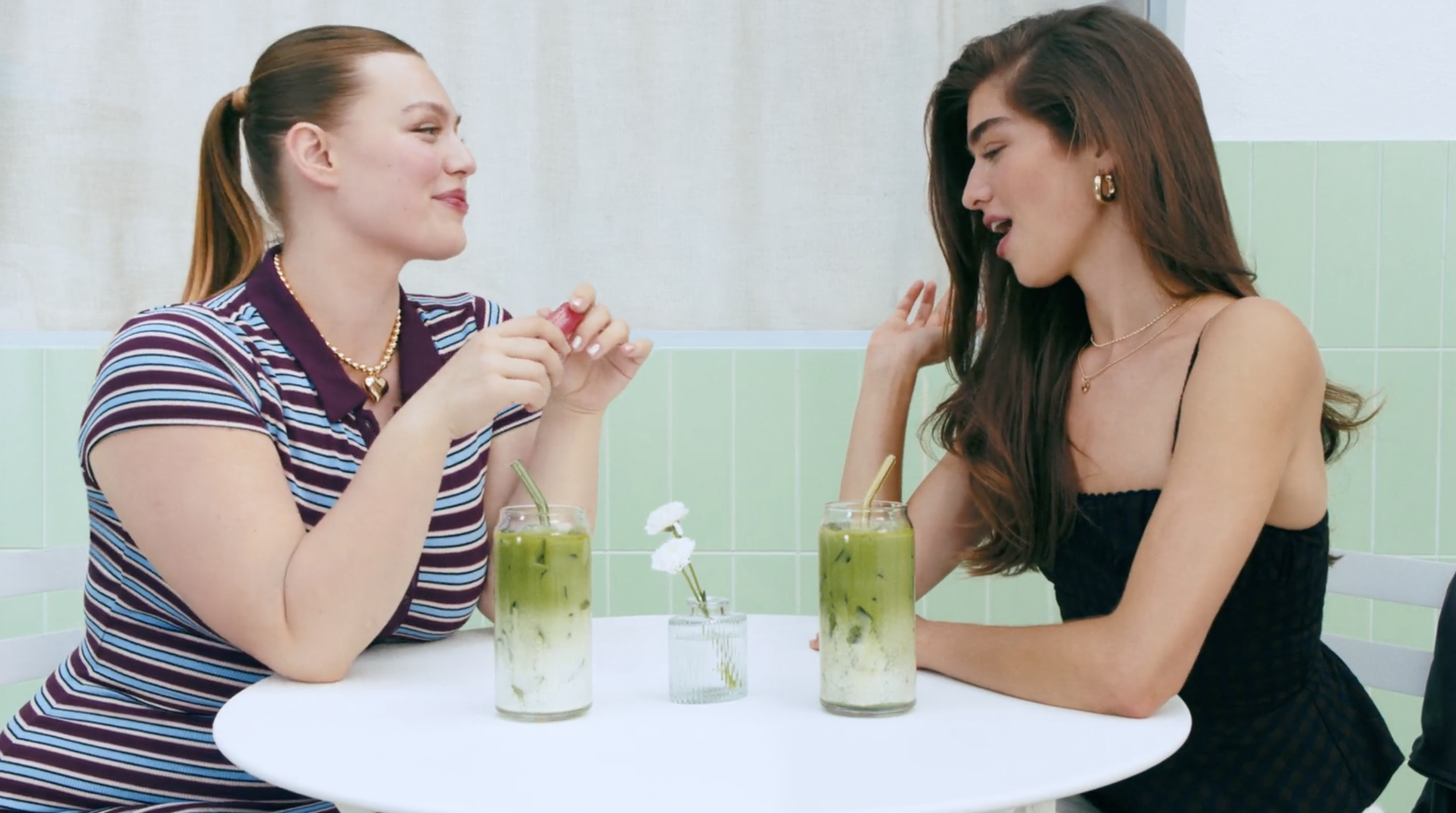Two women drinking matcha at a café