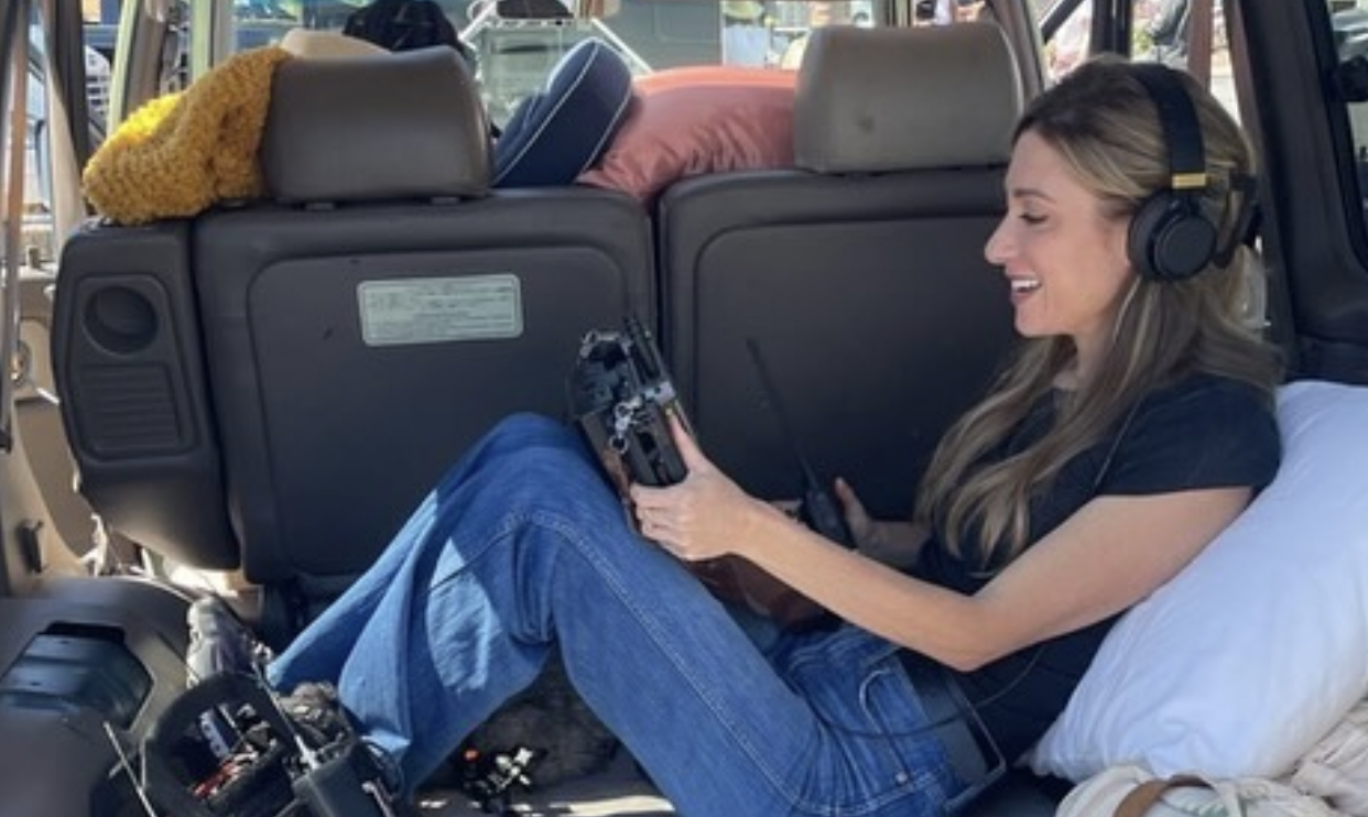 Director monitoring sound from the back of a production vehicle