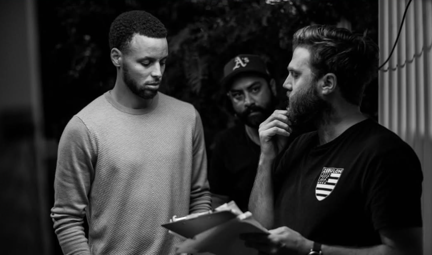 Steph Curry and Micah Perta reviewing a shot